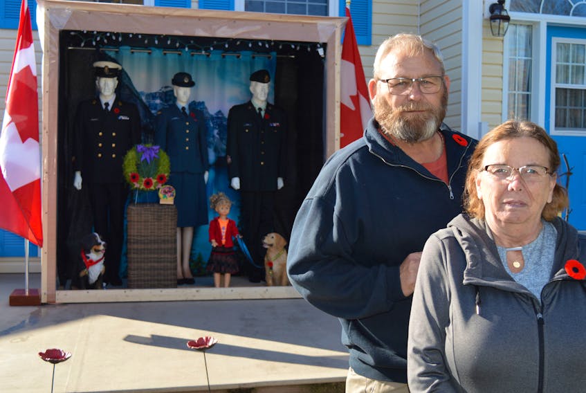 Dan Miller, left, and his wife, Phyllis, have created a large Remembrance Day tribute display that sits in from of their home on Upton Road in Charlottetown. Both of the Millers are veterans.