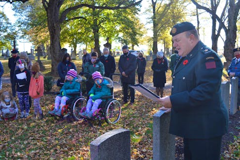 Rev. Maj. Tom Hamilton says a prayer during the No Stone Left Alone remembrance ceremony held Nov. 2 at the Sherwood Cemetery in Charlottetown. The Grade 4 class at Eliot River Elementary School took part, laying a wreath as well as poppies at the gravestone of each veteran. 
