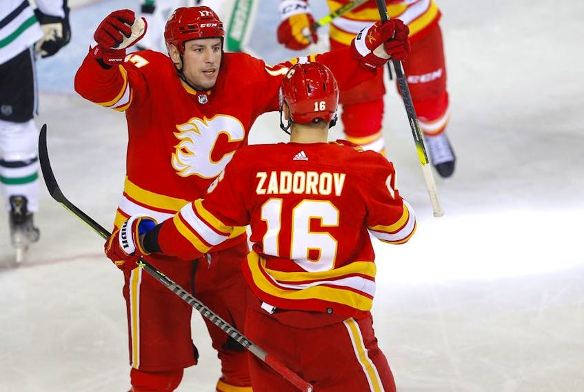The Calgary Flames’ Milan Lucic celebrates with Nikita Zadorov after scoring against the Dallas Stars at the Scotiabank Saddledome in Calgary on Thursday, Nov. 4, 2021.