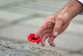 Remembrance Day ceremony at the National War Memorial in Ottawa in 2020. A war veteran leaves his poppy on the tomb of the unknown soldier.   
