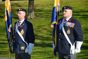 Honour guard members David Keeping, left, and Stephen MacLennan were part of an abbreviated Remembrance Day ceremony at the Ashby corner cenotaph in Sydney due to the pandemic last year. The service on Thursday in Sydney will once again take place at Veterans Memorial Park at Ashby corner. DAVID JALA/CAPE BRETON POST