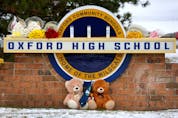  Stuffed bears and flowers are gathered at a makeshift memorial outside of Oxford High School on December 01, 2021 in Oxford, Michigan.