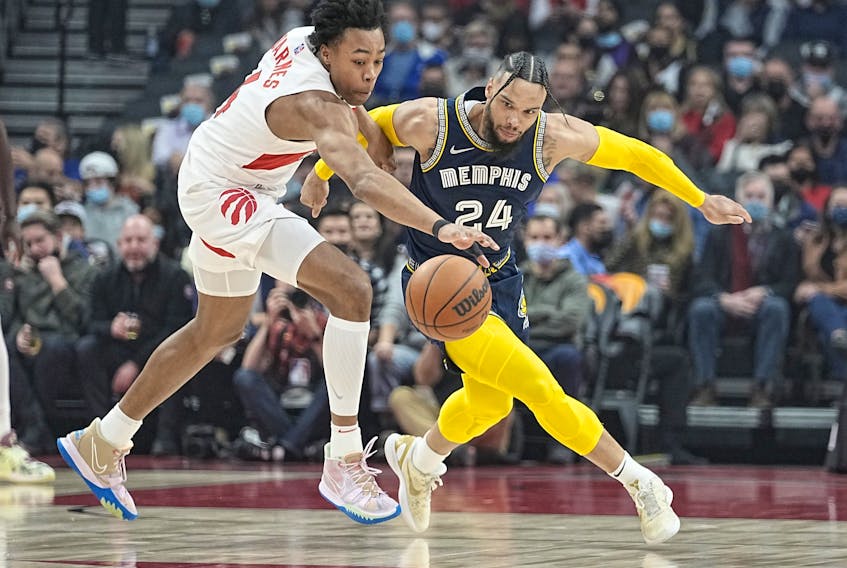 Raptors' Scottie Barnes (left) and Memphis Grizzlies' Dillon Brooks battle for the ball during the first quarter at Scotiabank Arena on Tuesday, Nov. 30, 2021. 