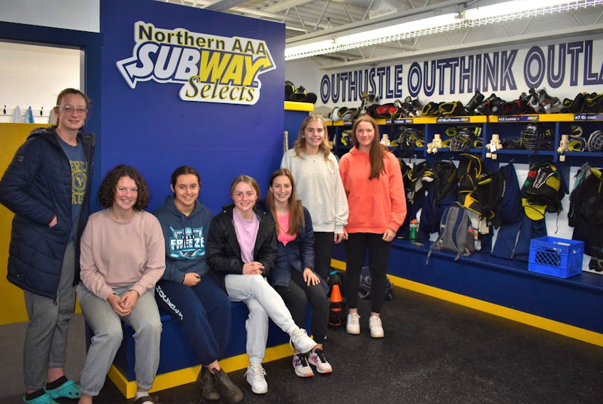 Members of the Northern Subway Selects Major U-18 team, including Bree MacPherson (left), Mairead MacPherson, Gabby Arsenault, Sara Stewart, Megan Smith, Julia MacDonald, and Brooke Thomson, gather for a photo is the team’s new dressing room at the Hector Arena.