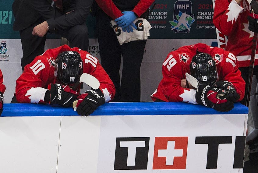 Dejected members of Team Canada sit on the bench after being defeated by the United States at the IIHF world junior championship gold-medal game on Jan. 5, 2021, in Edmonton.