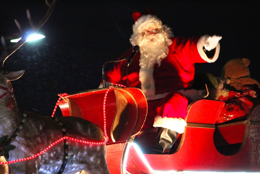 Santa Claus waved to the crowd from atop his sleigh during the annual nighttime Santa Claus parade through downtown Sydney in 2018. CAPE BRETON POST FILE