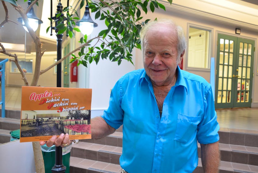 Historian Ken Bezanson of Port Williams with his latest historical calendar, titled Apples…Pickin’ em, Packin’ em, Shippin’ em. He said the calendar stands alone but also serves as a sequel to his last, Roll Out The Barrels. KIRK STARRATT