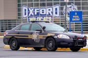 A police vehicle remains parked outside of Oxford High School on December 01, 2021 in Oxford, Michigan.