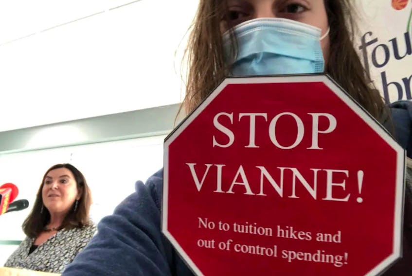 MUN student Matt Barter posted this photo to his social media sites and his website. The photo — of him holding the sign and MUN President Vianne Timmons — was taken during a recent media event. Barter has been banned from campus other than to attend classes and exams, or for medical appointments. Contributed
