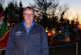 Stephen Stewart is surrounded by his Christmas display on Route 103 near Darnley, P.E.I. The display features 64 inflatables and hundreds of lights.