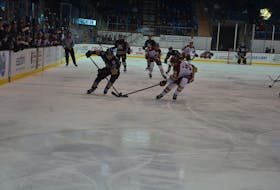 Charlottetown Islanders forward Sam Bowness, 29, and Acadie-Bathurst Titan defenceman Jaxon Bellamy battle for control of the puck during a Quebec Major Junior Hockey League game at Eastlink Centre on Dec. 10. Bowness is from Cornwall. The Titan won the contest 5-0.