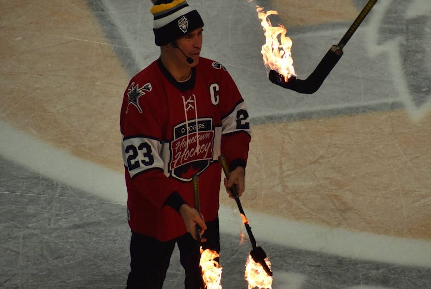 Paz of the Hockey Circus Show as part of Rogers Hometown Hockey entertains the crowd by juggling hockey sticks on fire during the second intermission of the Cape Breton Eagles game against the Drummondville Voltigeurs at Centre 200 on Saturday. JEREMY FRASER/CAPE BRETON POST.