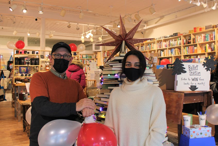 NovelTea held its official opening day on Dec. 11 with several chances to win at both its new cafe-bakery and book and gift store, on Prince Street and Inglis Place. Pictured at the bookstore are Keith Hazzard, creative designer and bookstore manager, and employee Tara Agha-Abbasi, who greeted visitors at the door.