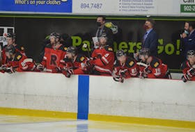 UNB Reds head coach Gardiner MacDougall, centre, follows the action against the UPEI Panthers in an Atlantic University Sport Men's Hockey Conference game at MacLauchlan Arena in Charlottetown earlier this season. MacDougall, from Bedeque, was recently inducted into the New Brunswick Sports Hall of Fame.