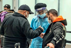 Travellers check in with a health-care screener after arriving at Toronto's Pearson International Airport on December 15, 2021.