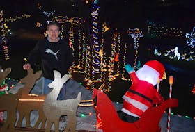 Darrell Aikens loves the view of lights best from the roof of his house.