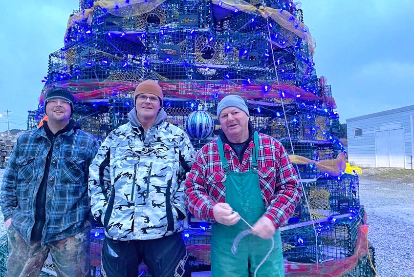 Cox’s Cove residents (from left) Adrian Park, Elwood Piercey and Alvin Park assembled a tree of memories made of 108 lobster pots as a tribute to fishermen past and present in the community. Local fisherman and businessman Rick Crane was also a part of the project and provided the pots for the tree.   