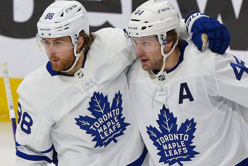 Toronto Maple Leafs defensemen Morgan Rielly (right) celebrating a goal against the Edmonton Oilers Tuesday, says that being on the road during COVID is something they are used to and happy they are playing.