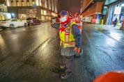 Parking attendant Sam Suos waves cars past the Bell Centre parking lot ahead of the Montreal Canadiens' game against the Philadelphia Flyers in Montreal on Thursday, Dec. 16, 2021 after the Canadiens were asked by Quebec's public health department to hold the game without fans. 