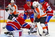 Montreal Canadiens' Cayden Primeau makes a save on shot by Philadelphia Flyers' Scott Laughton during overtime at the Bell Centre on Thursday, Dec. 16, 2021.