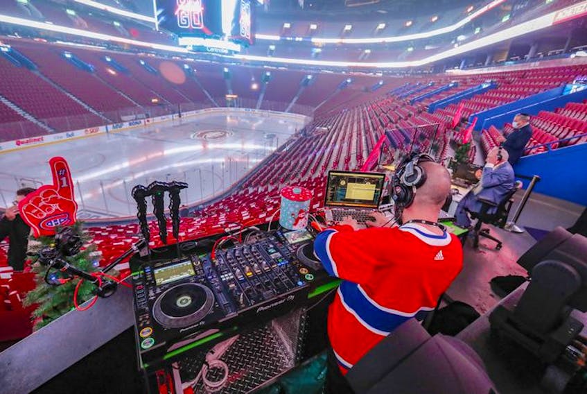 Disc jockey Vincent Aubry prepares to work in the empty Bell Centre prior to the Montreal Canadiens game against the Philadelphia Flyers on Thursday, Dec. 16, 2021.