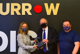 Dr. Megan Miller, chief physician recruiter of the medical society of P.E.I., left, Health Minister Ernie Hudson and Craig Harris, owner of Furrow Media, show off new virtual reality headsets that will offer physicians a tour of Island health facilities. 