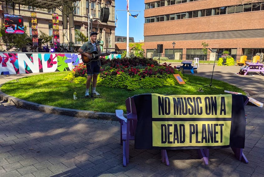 Halifax singer-songwriter Braden Lam plays behind the No Music on a Dead Planet banner. Contributed photo