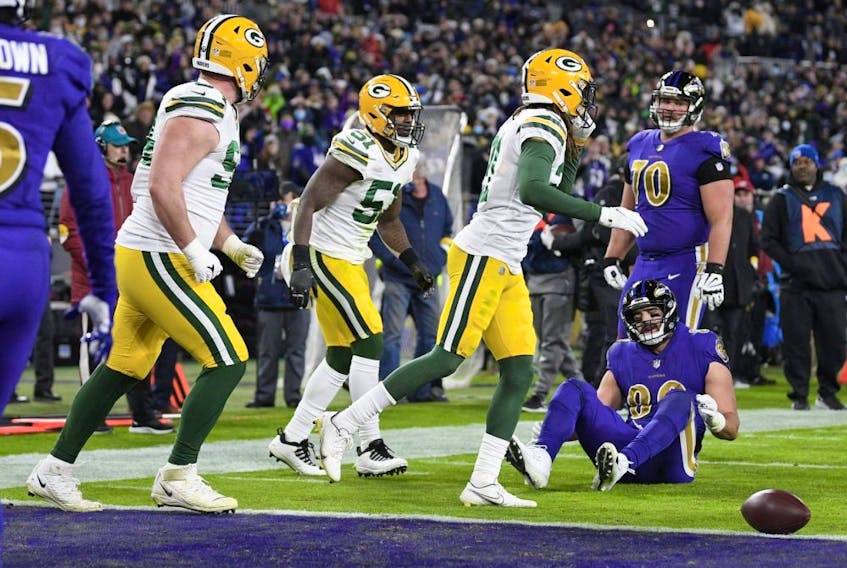 Members of the Green Bay Packers celebrate after a two-point conversion attempt to Baltimore Ravens tight end Mark Andrews (seated) failed in the second half of an NFL game Dec. 19, 2021, in Baltimore. Green Bay won 31-30. 