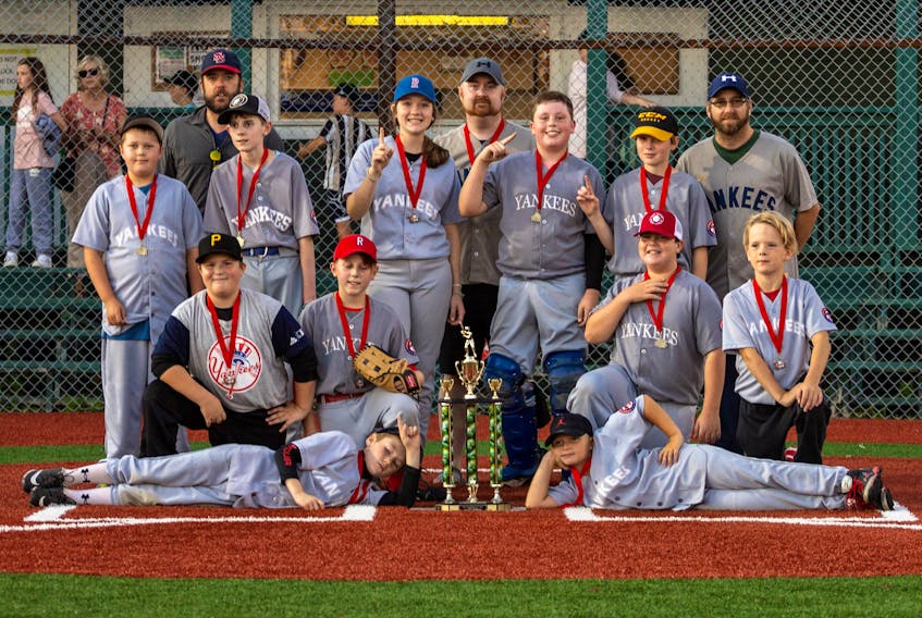On Sept. 23, the Yankees captured Sydney Mines and District Little League’s major division playoff championship, ending a very close series with the Red Sox at the Nicole Meany Memorial Ball Park. Front row, from left, Jude Petite and Brett MacMillan. Second row, from left, Matthew MacInnis, Alex Compton, Nicholas Eveleigh, and Michael Forrest. Third row, from left, Nathan Ivey, Seth Compton, Maia MacDougall, Breton Taylor, and Nole Murray. Back row, from left, Shane Petite (coach), Ryan Ivey (coach), and Matthew Eveleigh (coach). Missing from the photo was Dave Compton (coach). PHOTO CONTRIBUTED/DOUG IVEY. 