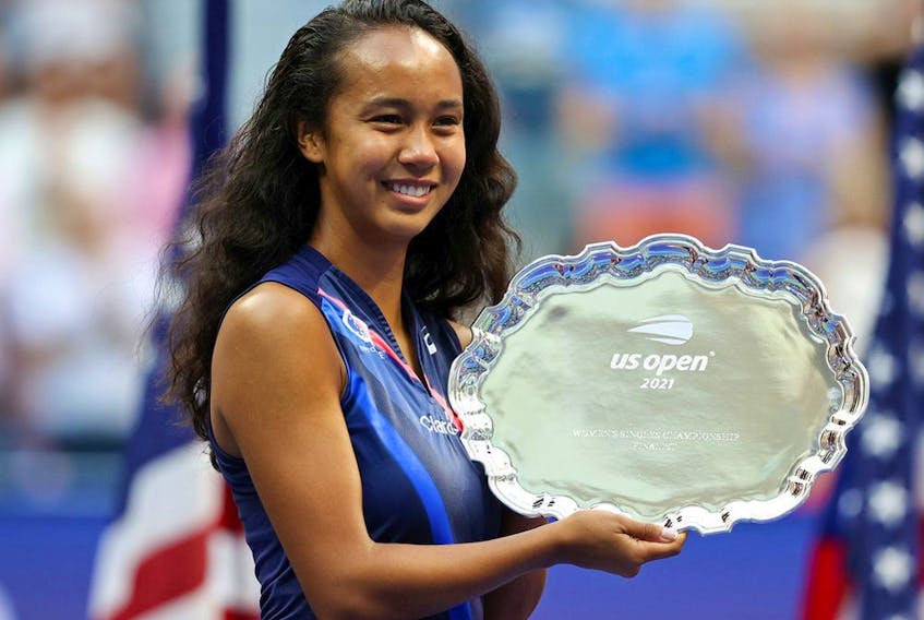 Laval's Leylah Annie Fernandez celebrates with the runner-up trophy after being defeated by Emma Raducanu of Britain at the U.S. Open in Flushing N.Y., on Sept. 11, 2021. 