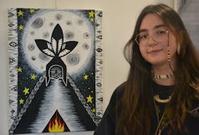 Eskasoni artist Chanelle Julian with her painting Grandmother Moon now on display at Better Bite Cafe inside Eltuek Arts Centre in Sydney. The eyes in the tree bark represent intuition. ARDELLE REYNOLDS/CAPE BRETON POST