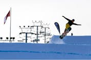 A snowboarder jumps off a ramp at WinSport . Azin Ghaffari/Postmedia