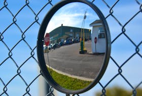 A lineup of vehicles is reflected in the security mirror at the Park St. COVID-19 testing clinic in Charlottetown in this file photo. 