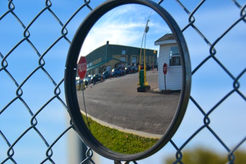 A lineup of vehicles is reflected in the security mirror at the Park St. COVID-19 testing clinic in Charlottetown in this file photo. 