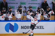 Canada's Landon Ferraro skates by the bench, getting congratulated by his teammates after scoring against Finland at the Channel One Cup tournament in Moscow last weekend.