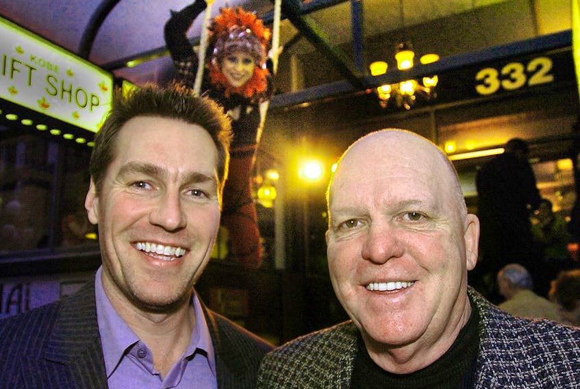  Former Vancouver Canuck coach Bob McCammon (right) and goalie Kirk McLean outside their new Restaurant in Gastown in 2007. The gymnast in backround was part of the public relations event.PNG Files