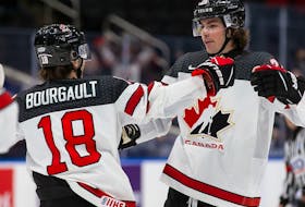 Xavier Bourgault (18) and Owen Power (25) of Canada celebrate a goal against Czechia during the 2022 IIHF world junior championship at Rogers Place on Sunday, Dec., 26, 2021.