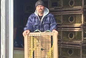 Mike Dixon, co-chair of LFA26A, pictured working on his traps in Grahams Pond Harbour on Dec. 29, said lobster fishermen in his area have voted in favour of moving setting day for the spring fishery up to April 26 next year to avoid having the season spill into molting season.

