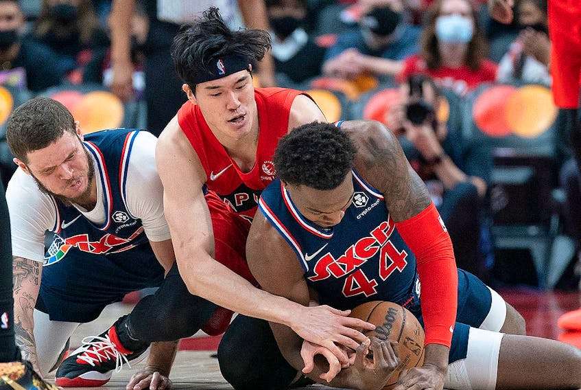 Toronto Raptors forward Yuta Watanabe (18) battles for the ball with Philadelphia 76ers forward Paul Reed (44)) at Scotiabank Arena. 