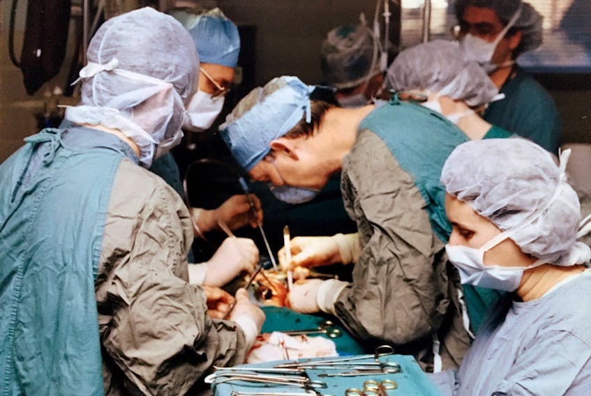 Dr. Allan S. MacDonald, centre, works on a transplant at the old Victoria General Hospital in Halifax in this undated photo. MacDonald, of Sydney, has been named a member of the Order of Canada for his pioneering innovations in the field of kidney, liver and pancreas transplantation. CONTRBUTED