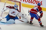 Montreal Canadiens' Christian Dvorak (28) tries for the return on Colorado Avalanche goaltender Jonas Johansson during second period in Montreal on Thursday, Dec. 2, 2021. 