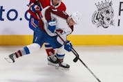 Montreal Canadiens' Ryan Poehling (25) and Colorado Avalanche's Devon Toews (7) try to get to the puck during second period in Montreal on Thursday, Dec. 2, 2021. 