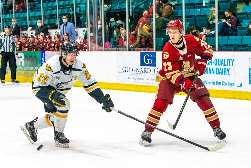 Jacob Melanson of the Acadie-Bathurst Titan, right, attempts to make a pass as he's pressured by Cape Breton Eagles defenceman Sean Larochelle during Quebec Major Junior Hockey League action at the K.C. Irving Regional Centre on Friday. The Titan won the game 9-1. Photo contributed/Bryannah James, Acadie-Bathurst Titan.