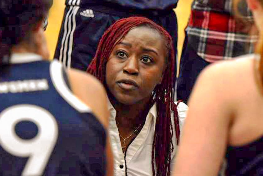Lee Anna Osei directs the St. Francis Xavier X-Women players during an AUS game. - St. F.X. University