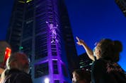 Calgarians watch 10-metre tall David, North America's largest marionette, make "The Ascent" – a climb of the 37-storey Devon Tower in Calgary. The event was part of this year's Beakerhead festival on Sept. 25, 2021. 
Gavin Young/Postmedia