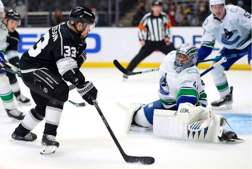 Viktor Arvidsson of the Los Angeles Kings shoots the puck against Jaroslav Halak of the Vancouver Canucks during the second period at Crypto.com Arena on December 30, 2021 in Los Angeles, California.