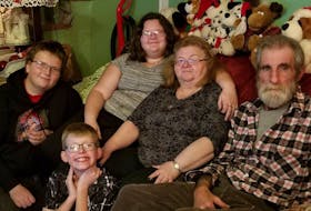 Winnie Sommers (second from right) and her husband Lloyd (far right) sit with their grandchildren Deevon (far left), Jayden (second from left) and Natalia.