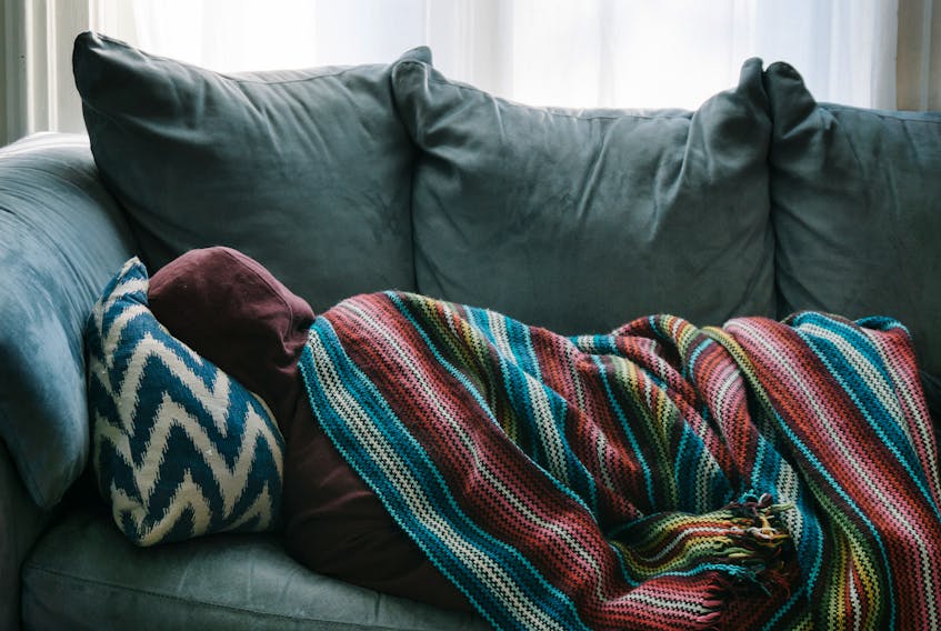 Stock photo of person on couch. - Photo by Rex Pickar on Unsplash