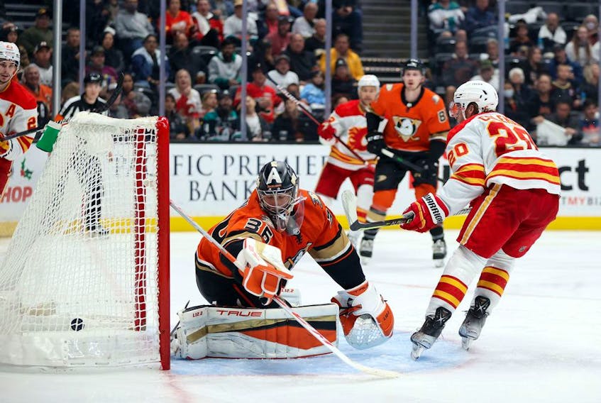 The Calgary Flames’ Blake Coleman scores a goal against Anaheim Ducks goaltender John Gibson at Honda Center in Anaheim, Calif., on Friday, Dec. 3, 2021.