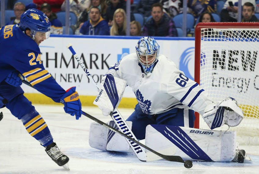 Maple Leafs goaltender Joseph Woll makes the first save of his NHL career, stopping Sabres' Dylan Cozens in the opening minute of his debut on Saturday, Nov. 13, 2021, in Buffalo, N.Y. 